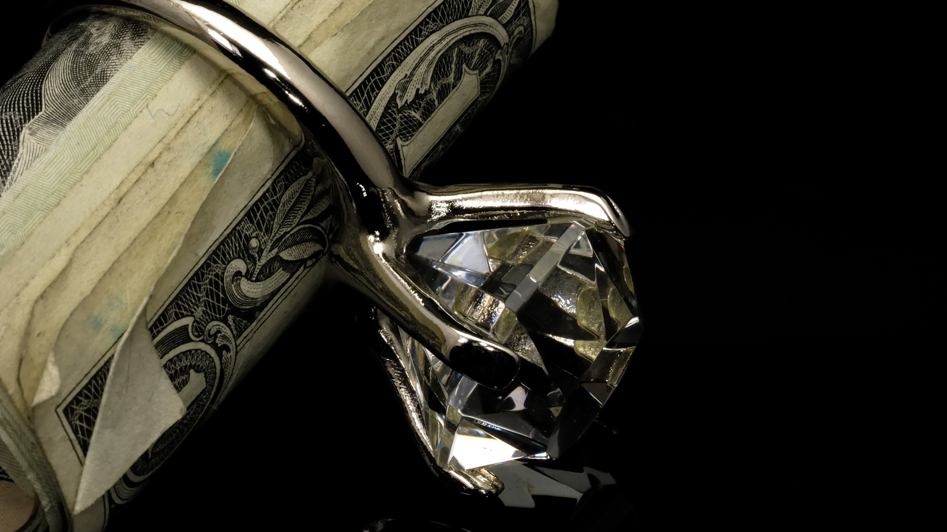 an engagement ring is wrapped around dollar bills
