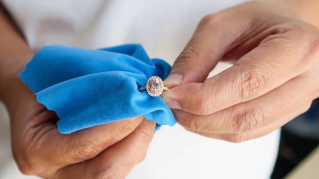 a jeweler shows how to care for your jewelry by polishing it