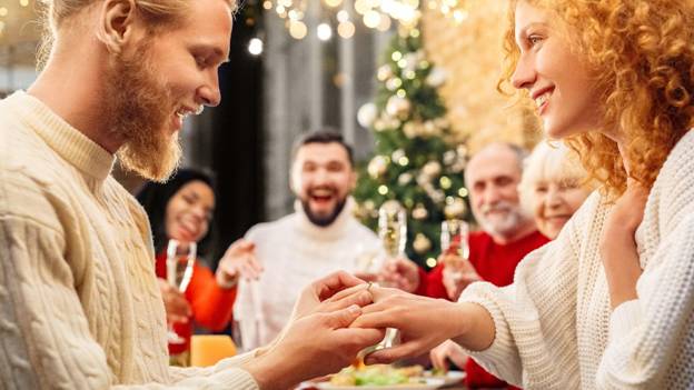 a marriage proposal surrounded by friends and family