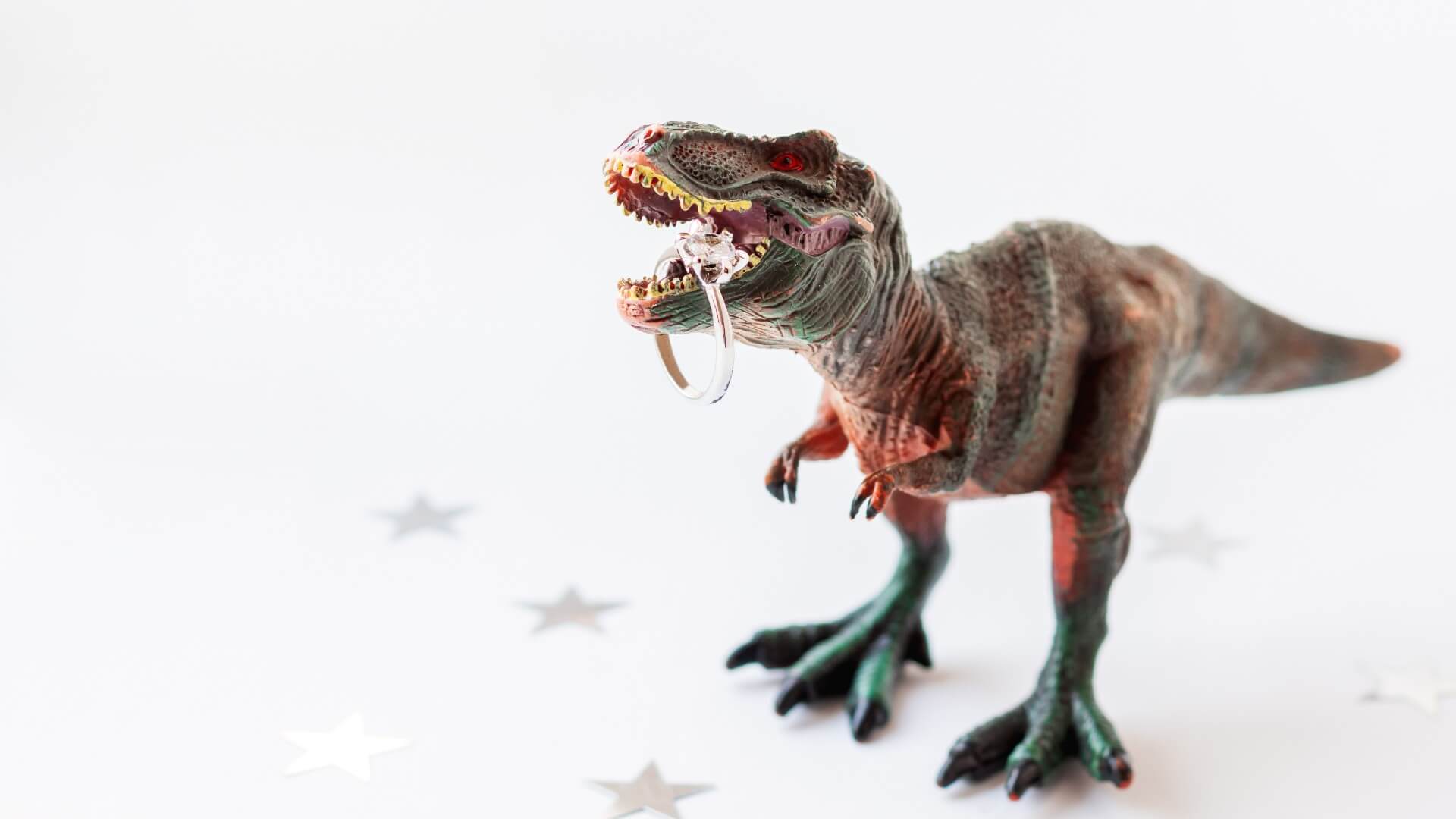 Model dinosaur holding engagement ring | Get Creative | Allurez
