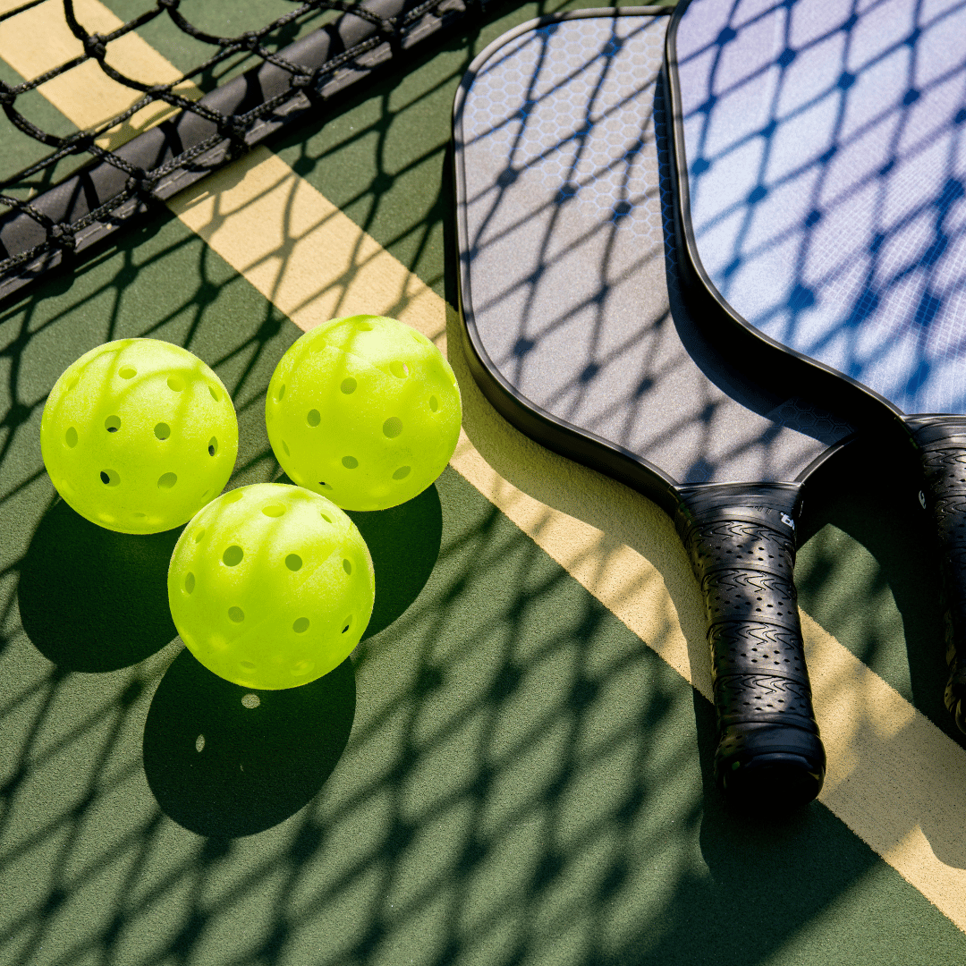 pickleball court with pickleball paddles and pickleball balls