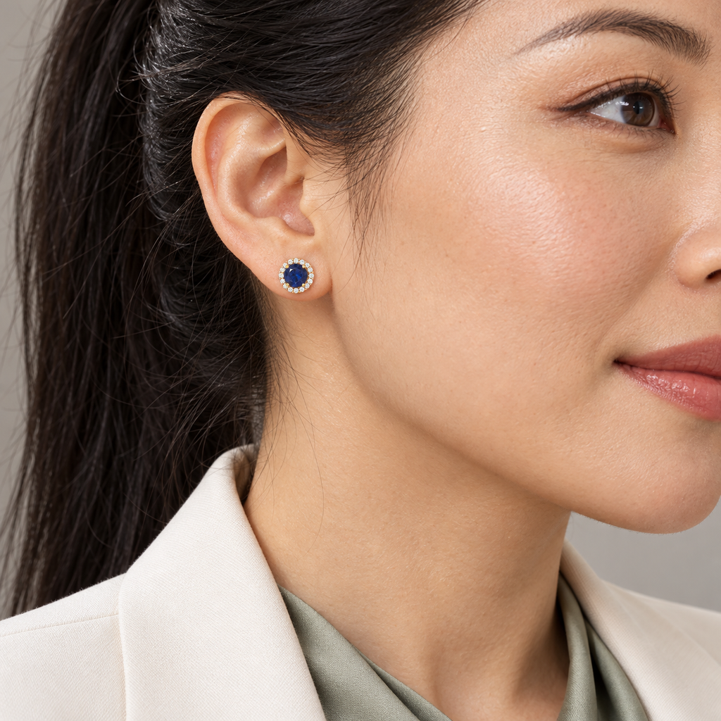 Natural blue sapphire diamond halo stud earrings — close-up ear model, 6.16 mm studs