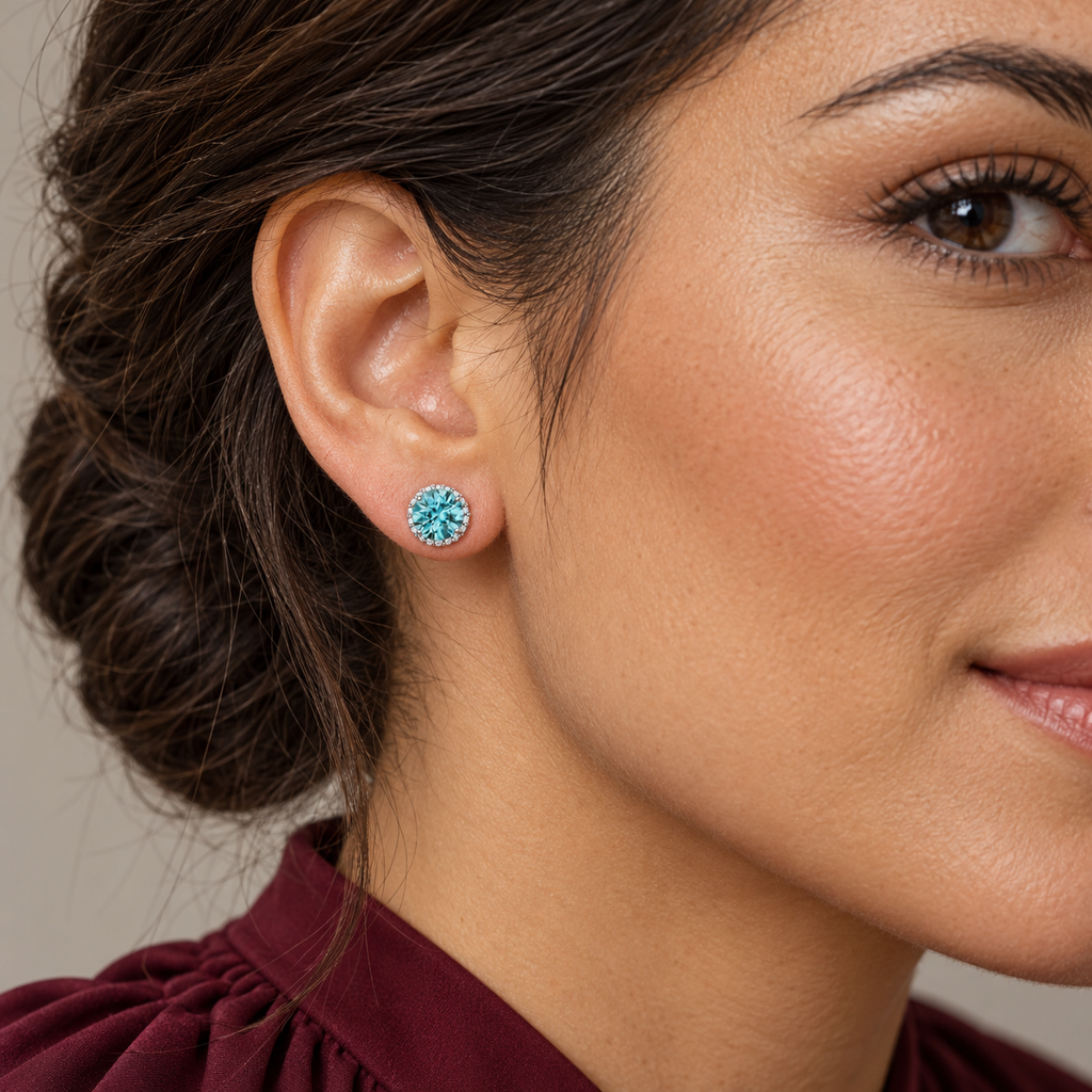 Natural blue zircon halo stud earrings — close-up ear model, 6.16 mm stud