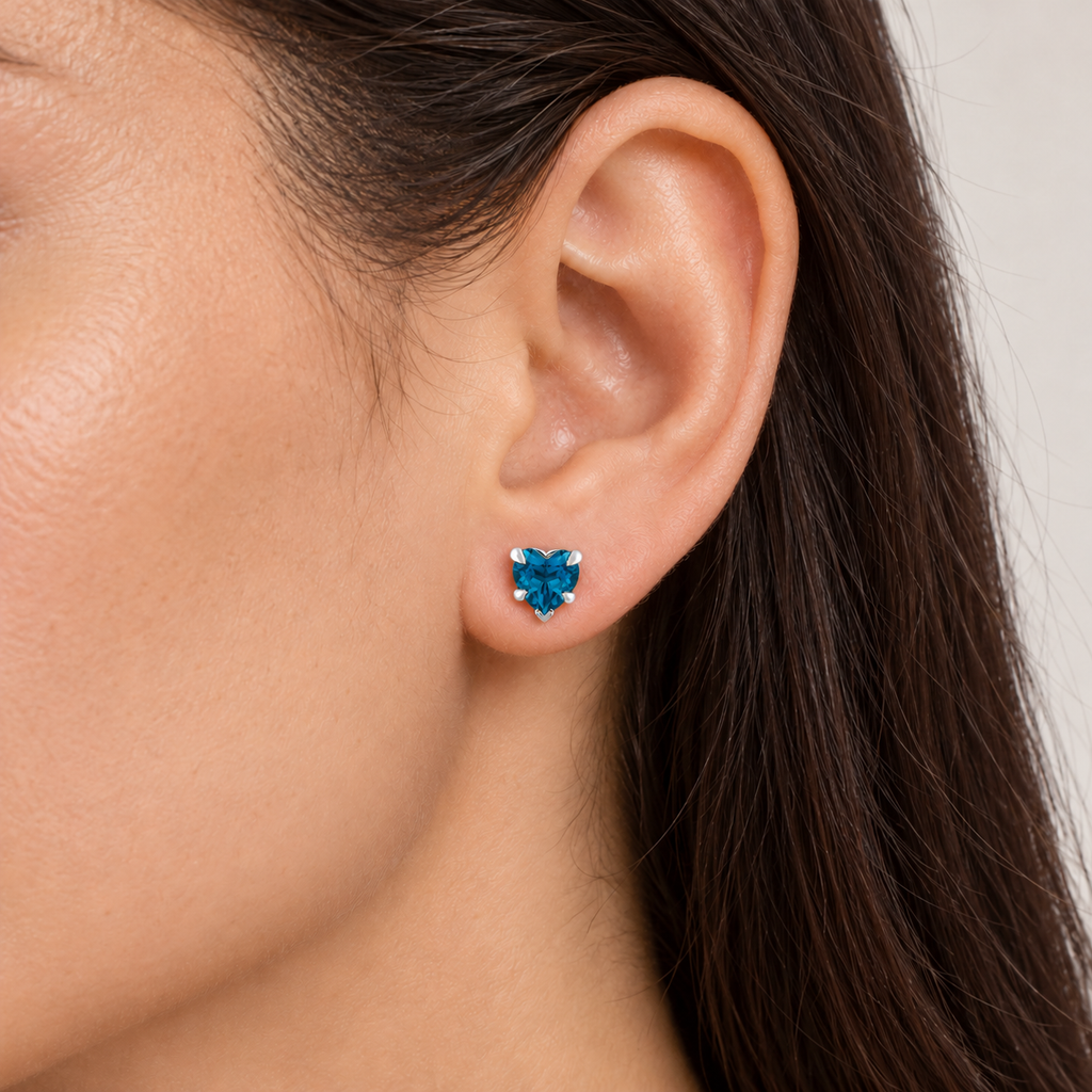 Heart natural blue topaz stud earrings Sterling Silver — close-up model view