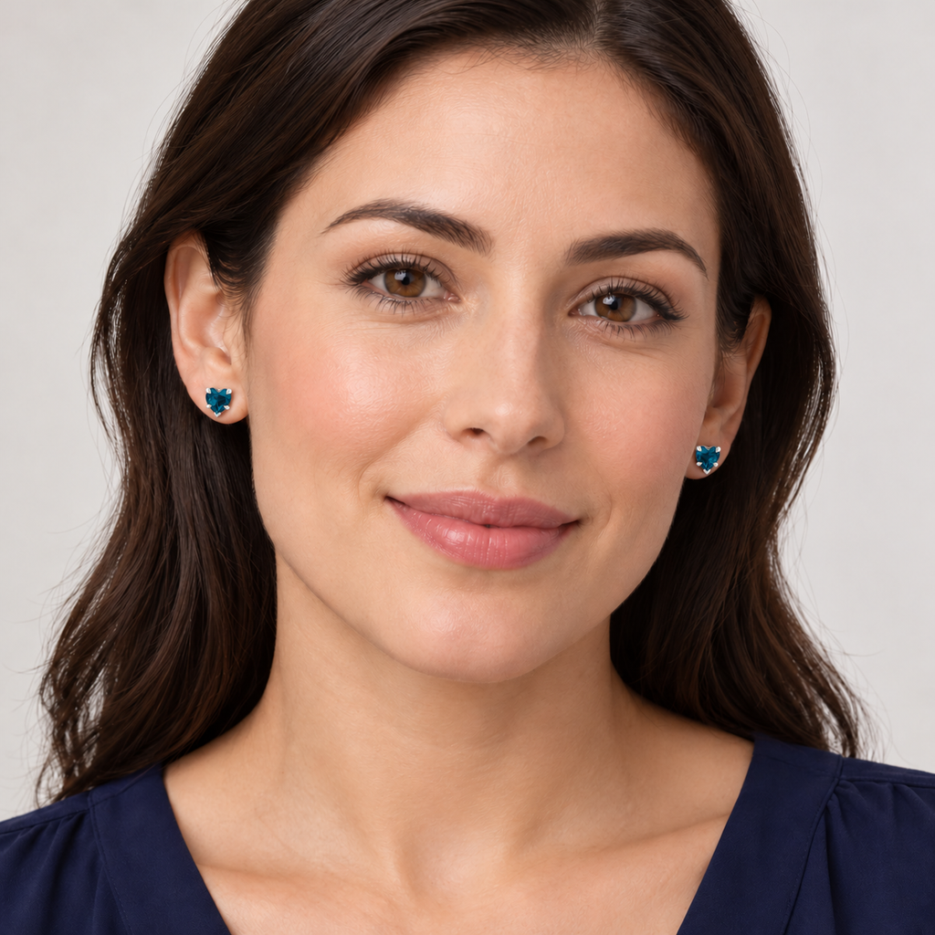 Heart natural blue topaz stud earrings Sterling Silver — full-face model view