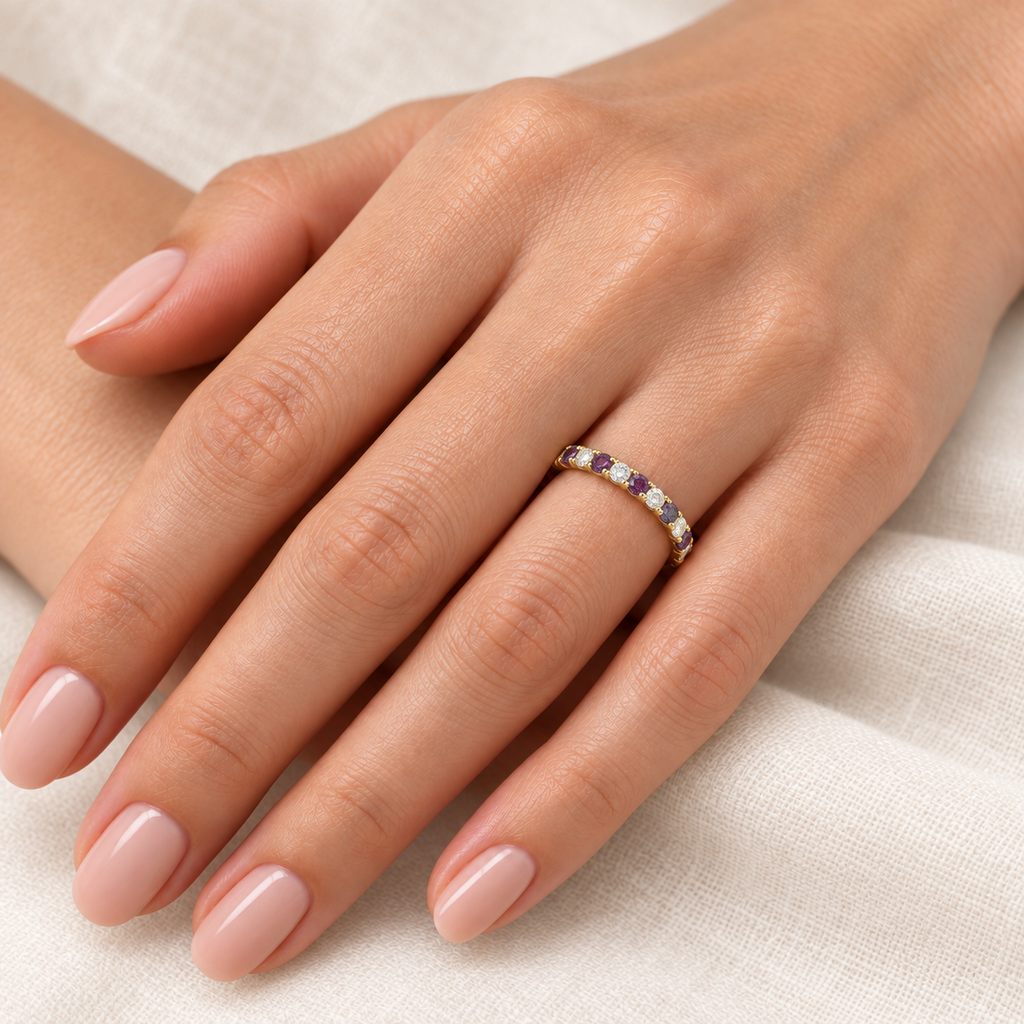 Lab-grown alexandrite and diamond 14K yellow gold 2 mm eternity band on left hand, ivory linen closeup