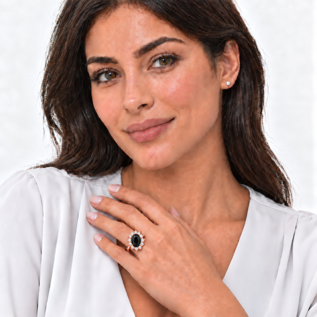 Model wearing oval natural black onyx and 12-diamond halo ring in 18k rose gold on left ring finger