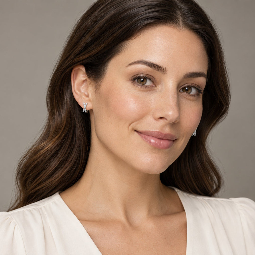 AZ29551LG — full-face model wearing 9.7 mm crossover lab-grown diamond mini huggie earrings in 14K White Gold; illustrative scale.