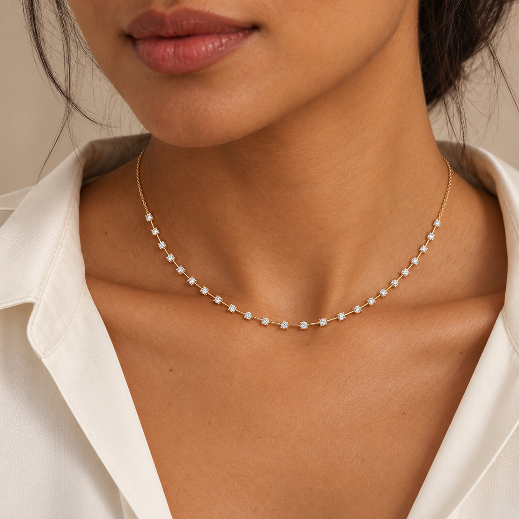 Interval diamond tennis necklace in 14K yellow gold on a new model, close-up; illustrative scale.; reference design; reference design