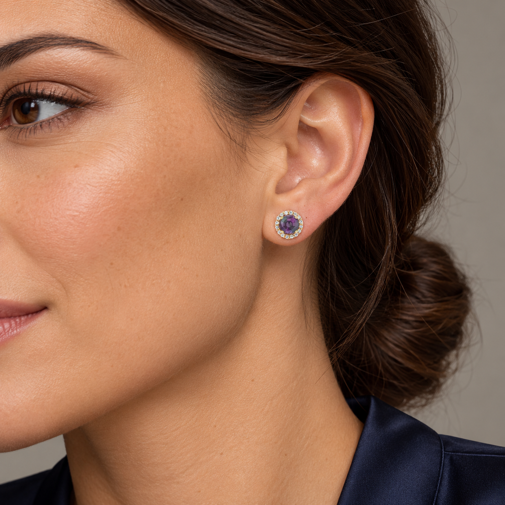 Close-up model wearing 3.5mm natural alexandrite and diamond halo stud earrings in 14K Yellow Gold