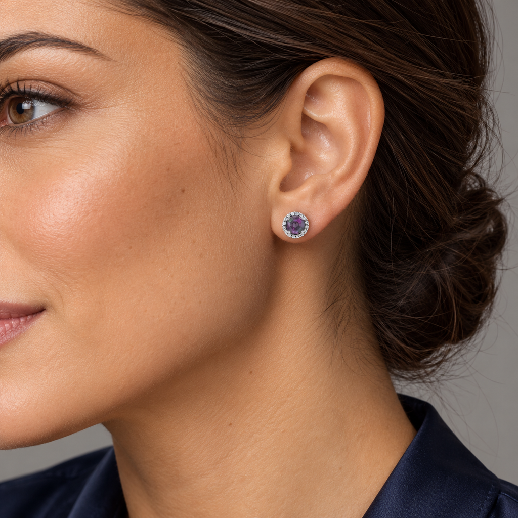 Close-up model wearing 3.5mm natural alexandrite and diamond halo stud earrings in Sterling Silver