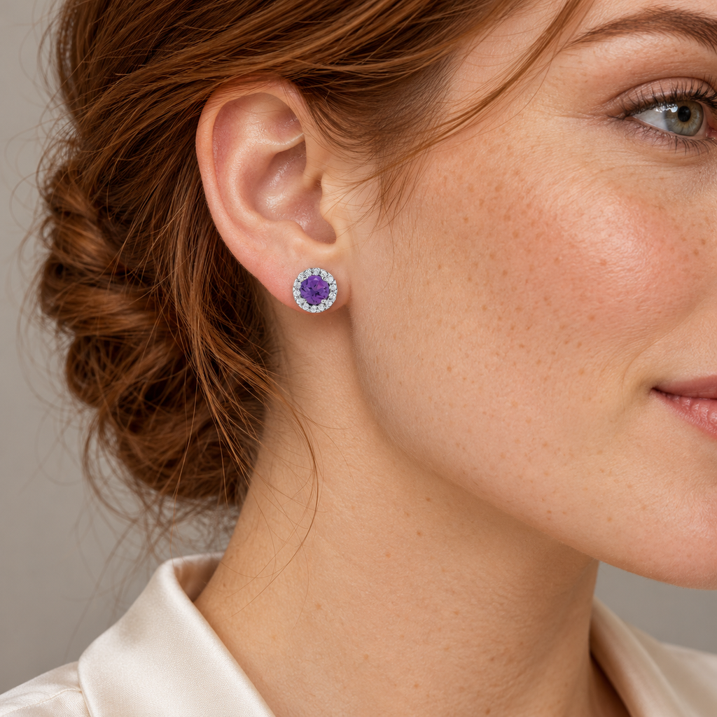 Close-up model wearing natural amethyst and diamond halo stud earrings in 14K White Gold