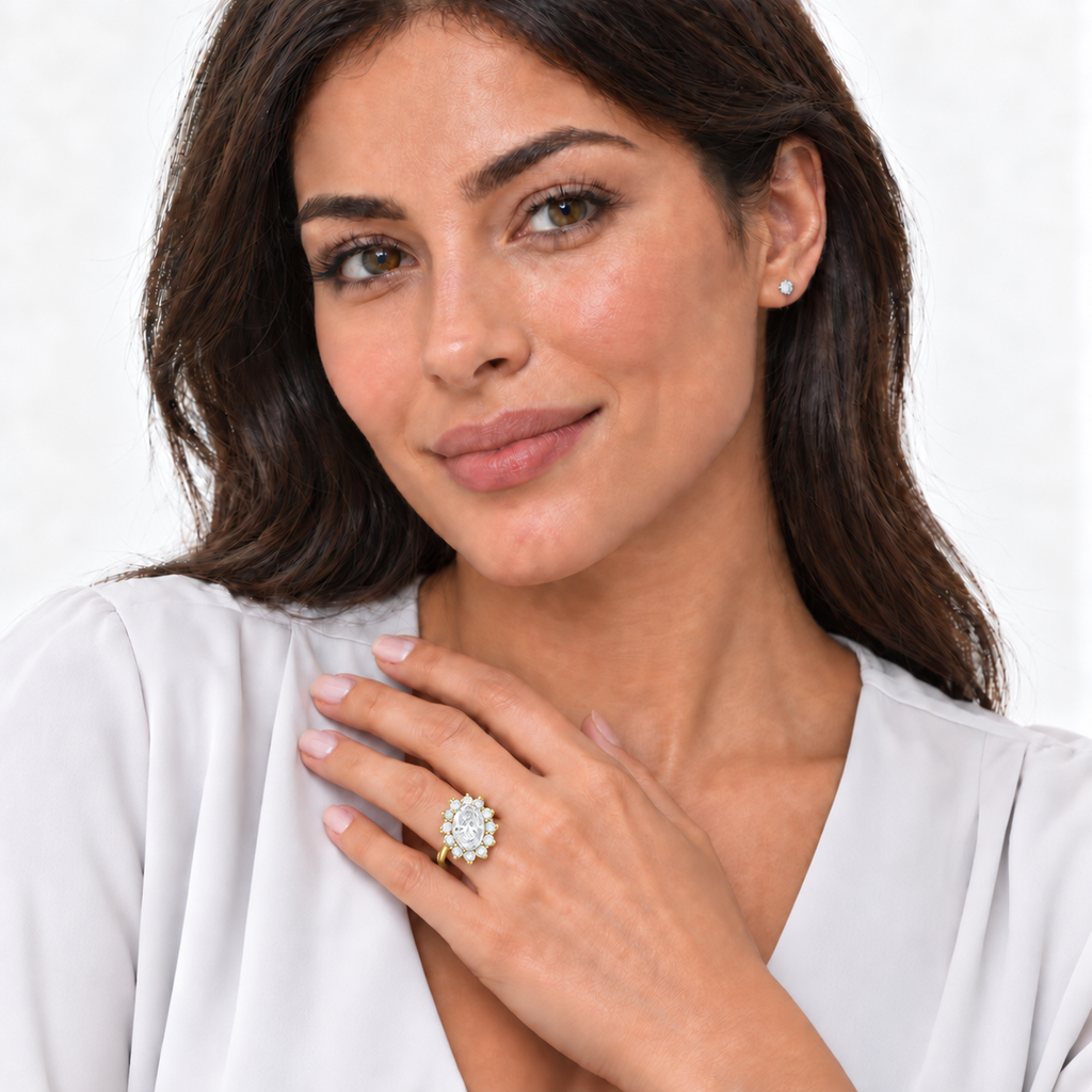 Model wearing oval lab-grown diamond and 12-diamond halo ring in 14k yellow gold on left ring finger