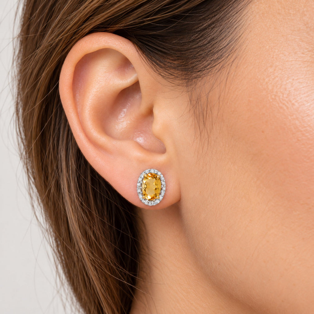 Oval Lab Citrine & Lab Diamond Halo Stud Earrings 14K Yellow Gold 0.94ct, close-up model view