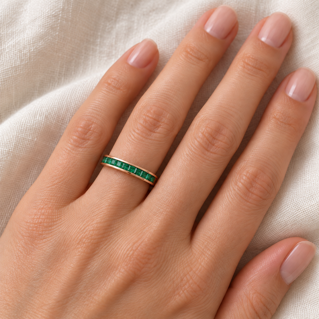 Lab emerald princess-cut 3 mm eternity band in 14k rose gold — ivory linen close-up
