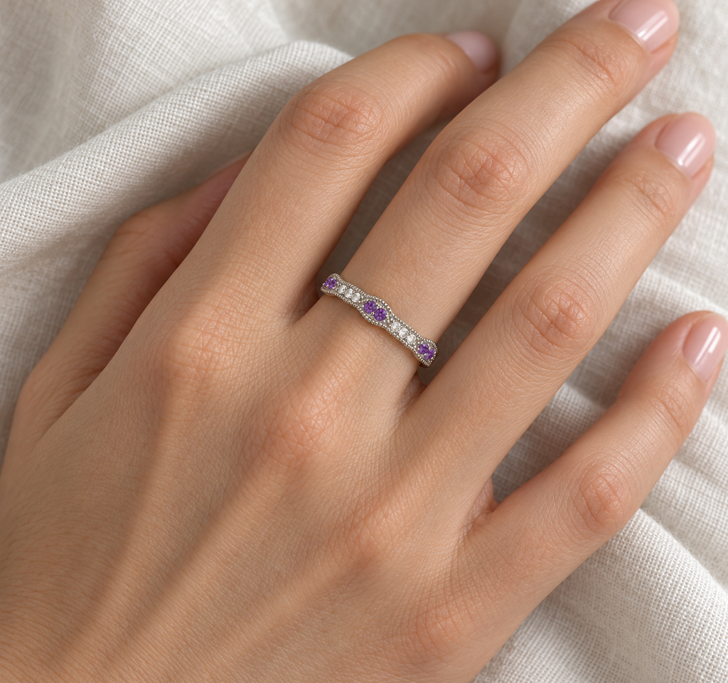 Natural amethyst and diamond vintage stacking band in 14k white gold on left hand over ivory linen