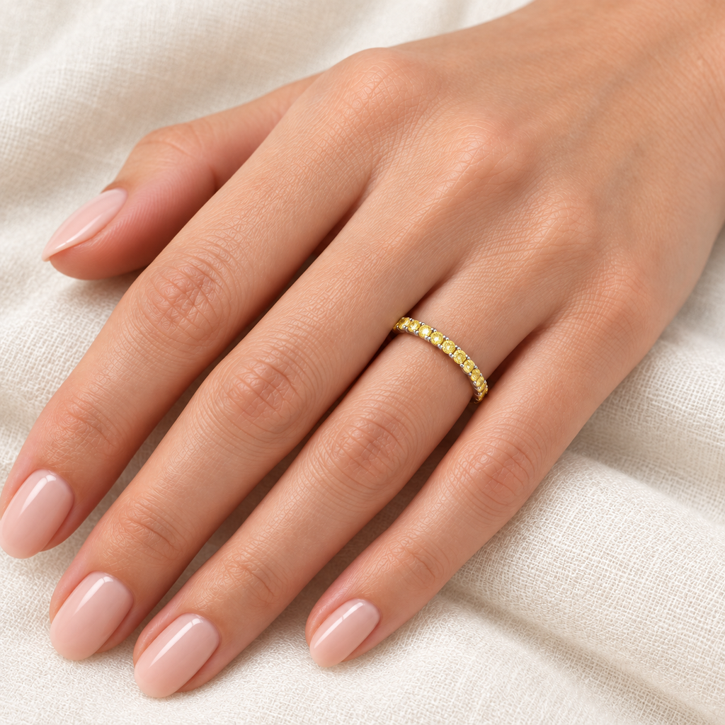 Fancy yellow canary diamond palladium 2 mm eternity band on left hand, ivory linen closeup