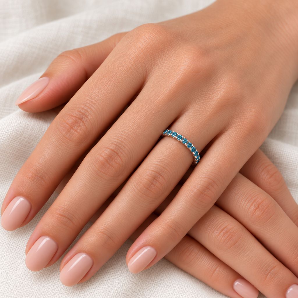 Fancy blue diamond 14K white gold 2 mm eternity band on left hand, ivory linen closeup