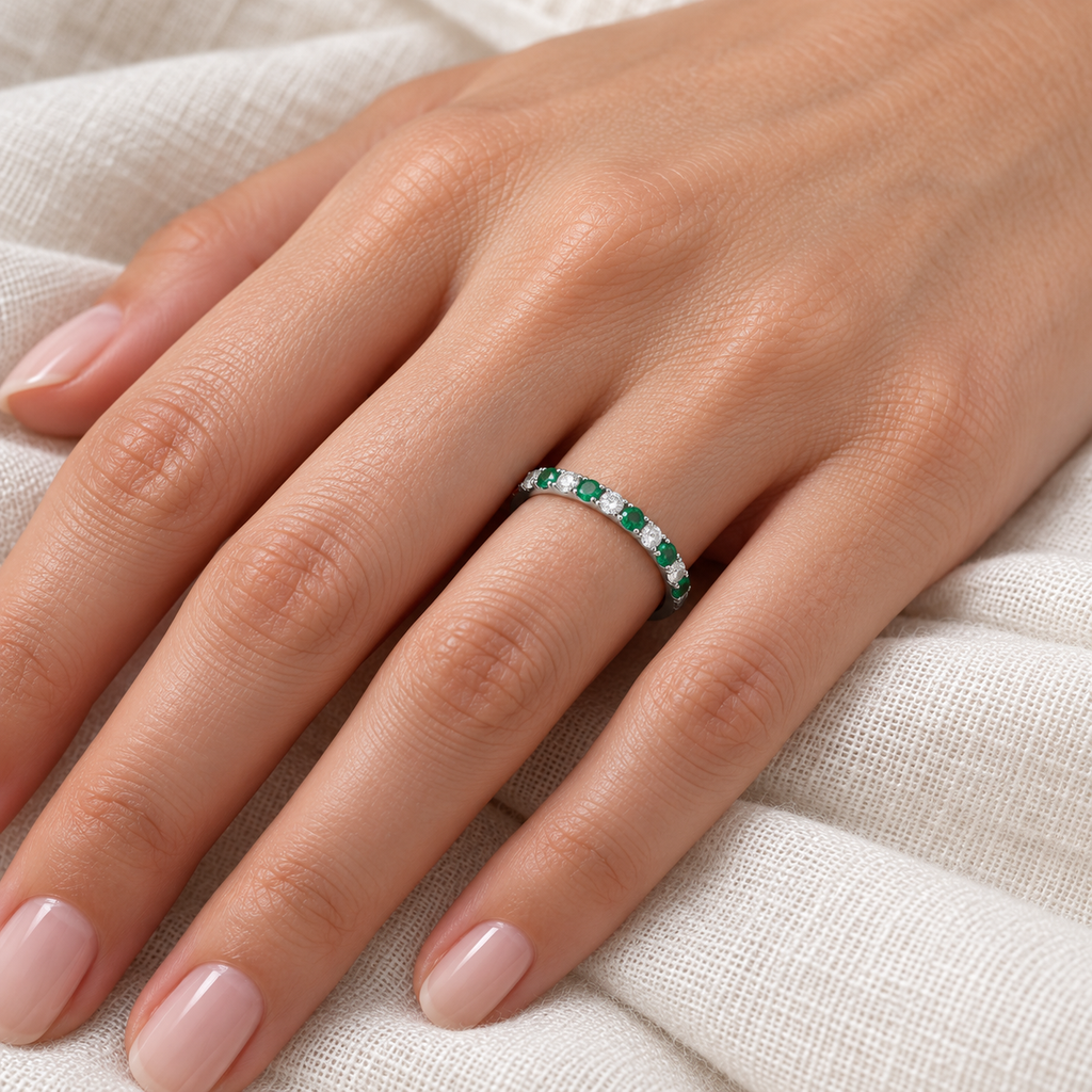 Lab emerald and lab diamond 2mm band in 14k white gold — ivory linen close-up on left ring finger