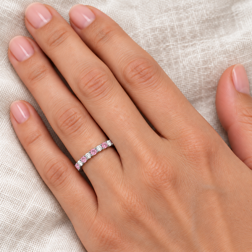 Lab-grown pink sapphire and lab-grown diamond 2 mm band in 14k white gold — ivory-linen close-up on left ring finger