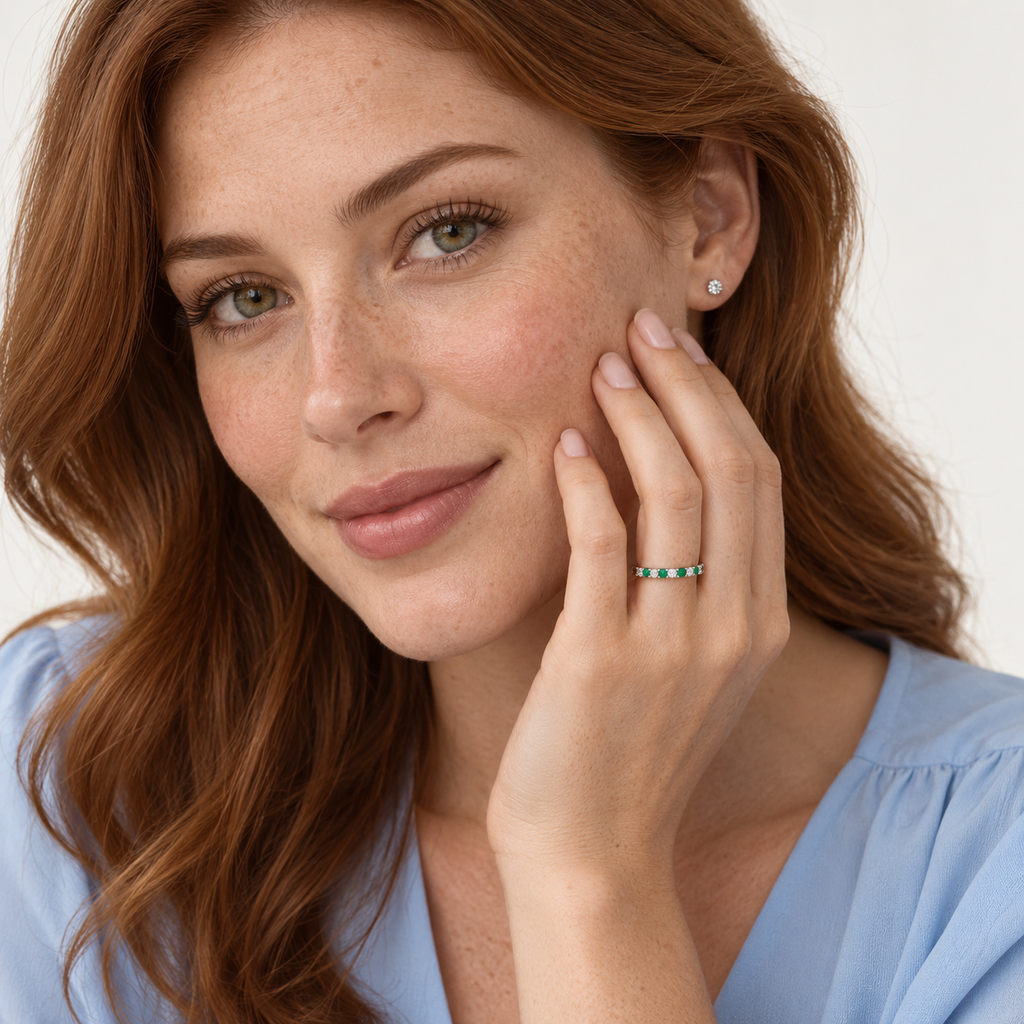Lab-grown emerald and lab-grown diamond 14K white gold eternity band worn in professional studio portrait