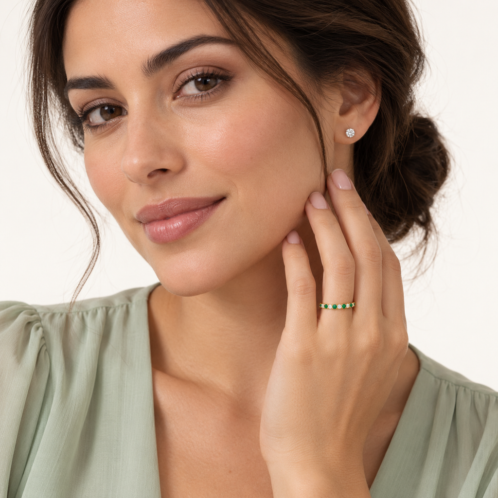 Lab-grown emerald and lab-grown diamond 14K yellow gold 2 mm eternity band worn in professional studio portrait