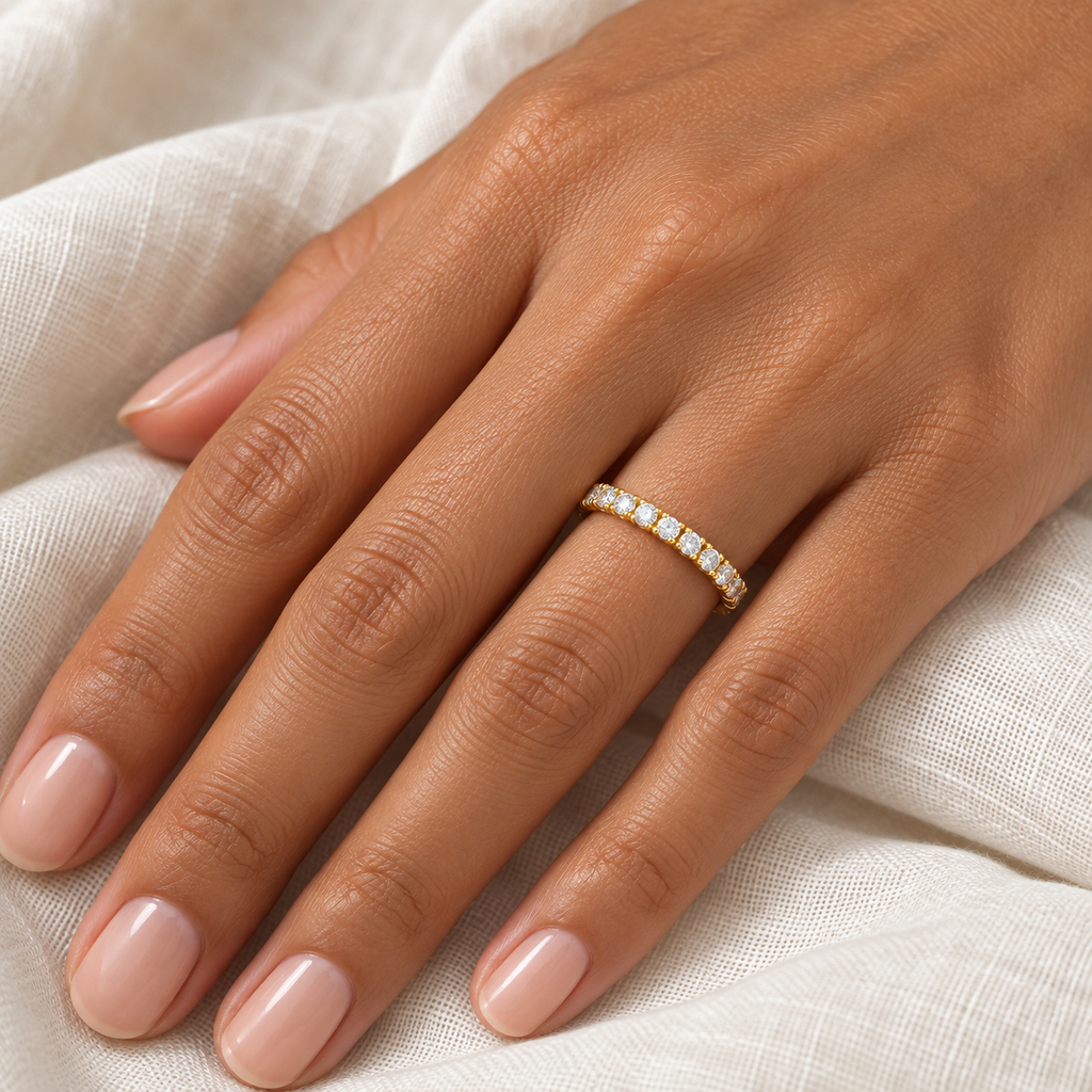 Diamond 14K yellow gold 2 mm eternity band on left hand, ivory linen closeup