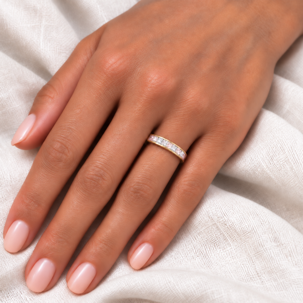 14k rose gold, 4mm, five lab pastel pink sapphires alternating four lab-grown princess-cut diamonds, 0.73ctw on left ring finger at base, ivory linen closeup