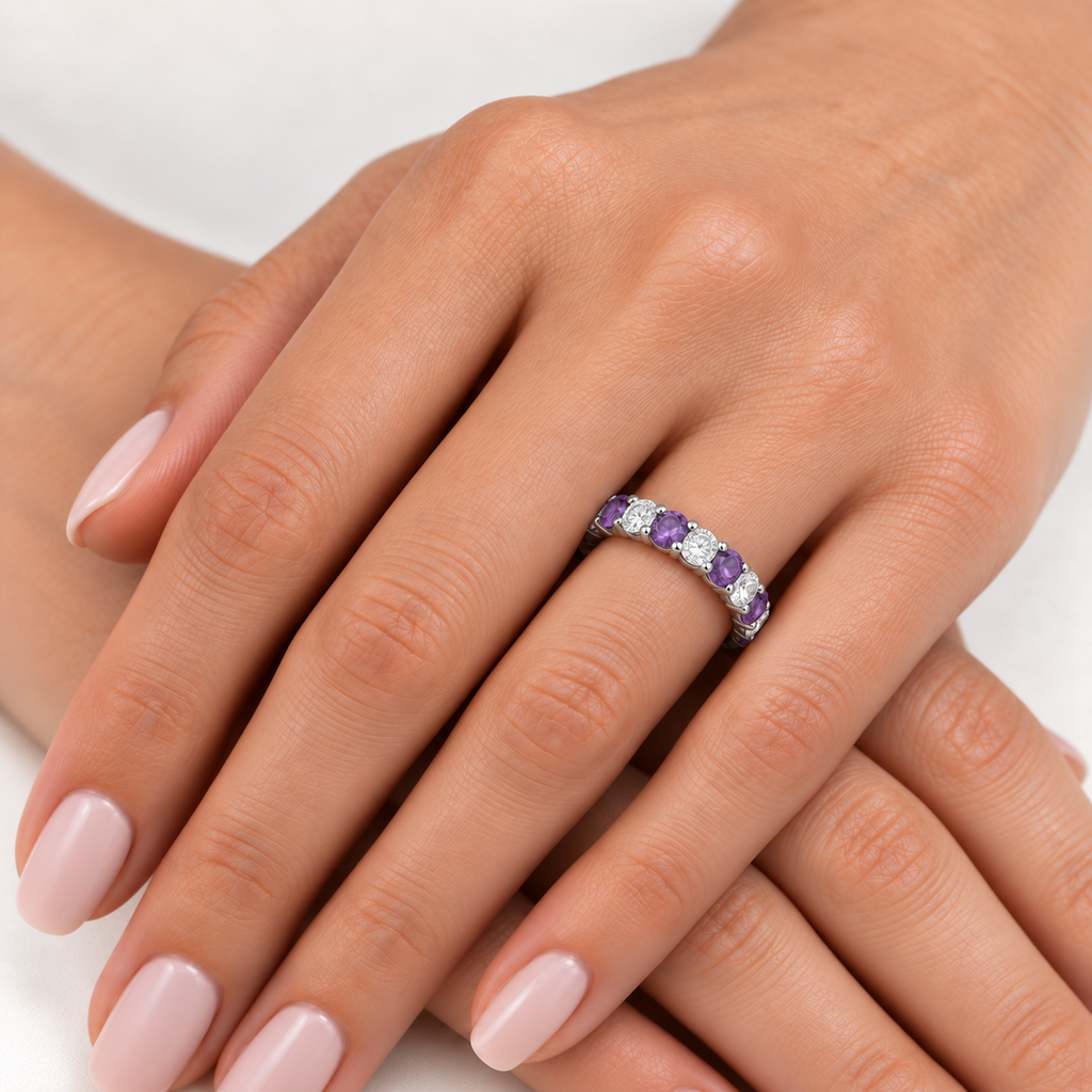 Eternity diamond and amethyst anniversary ring band in 14k white gold on left hand, ivory linen closeup
