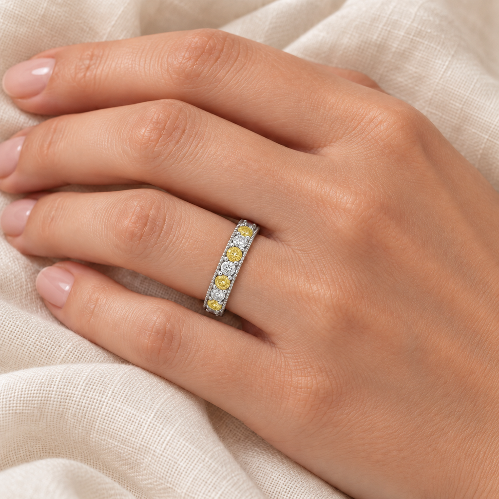 IR190 alternating natural fancy-yellow and white diamond milgrain band on left ring finger, ivory linen close-up