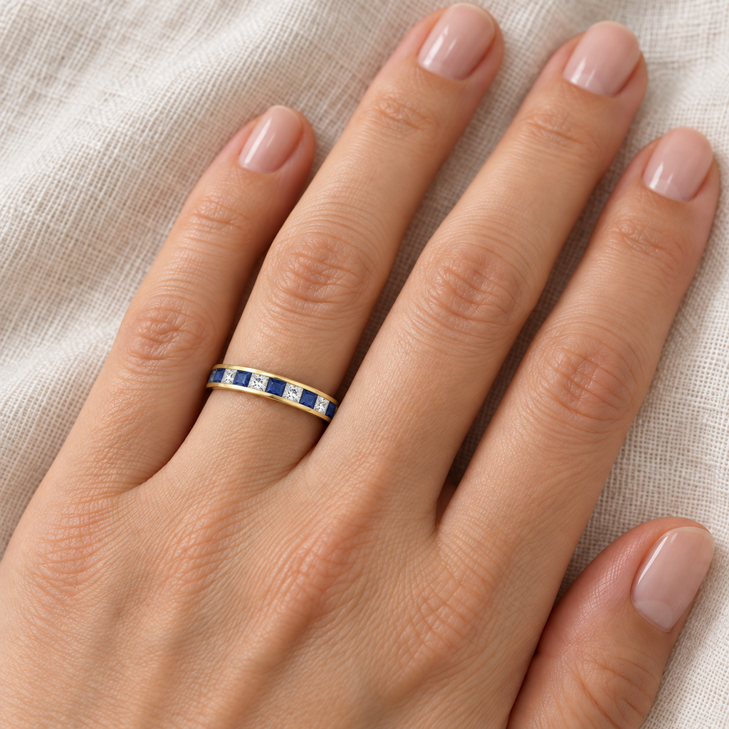 Princess-Cut Lab Sapphire & Diamond Eternity Ring 14k Yellow Gold (1.26ct) — 3 mm band on left ring finger, ivory linen close-up