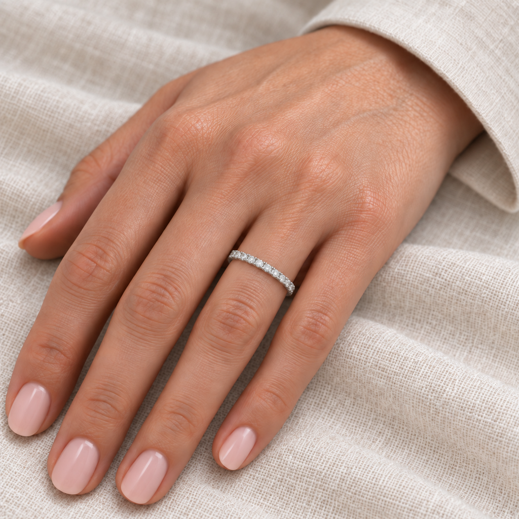 Diamond 14K white gold 2 mm eternity band on left hand, ivory linen closeup