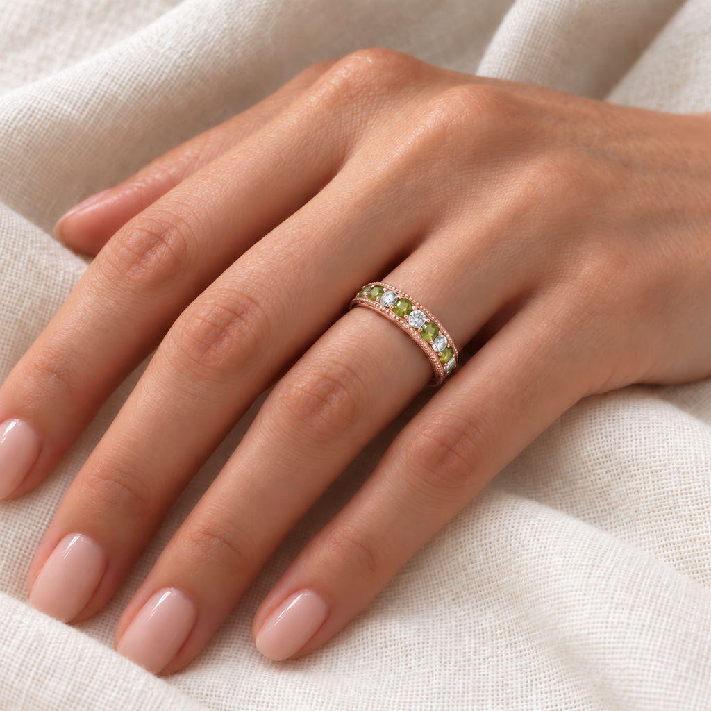 IR2304 peridot and diamond 4mm filigree band in 14K rose gold on left hand over ivory linen