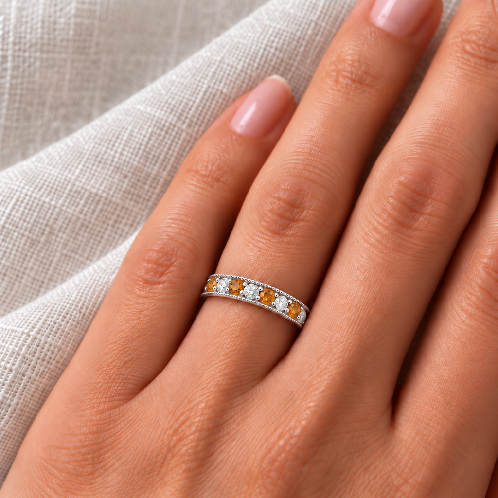Citrine and diamond white gold band on left ring finger, ivory linen closeup