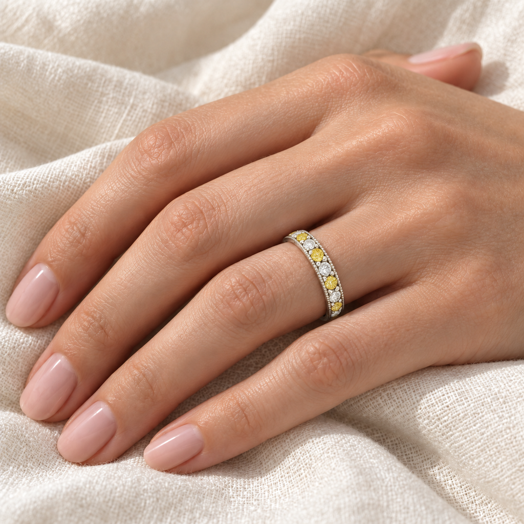 Fancy yellow canary and white diamond anniversary band in 14K white gold, 0.30ct ivory linen hand close-up