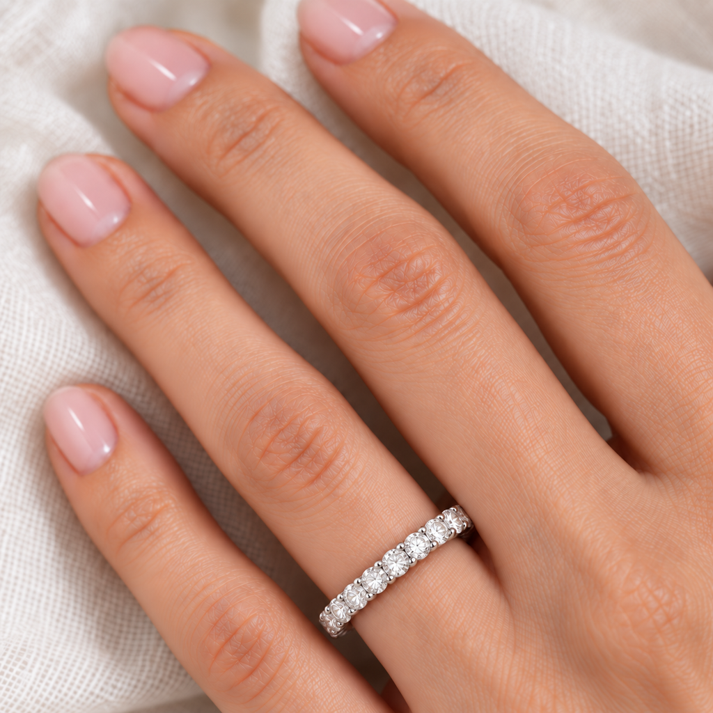Lab Diamond Eternity Ring Wedding Band 14k White Gold (2.50ct) — close-up on left hand over ivory linen