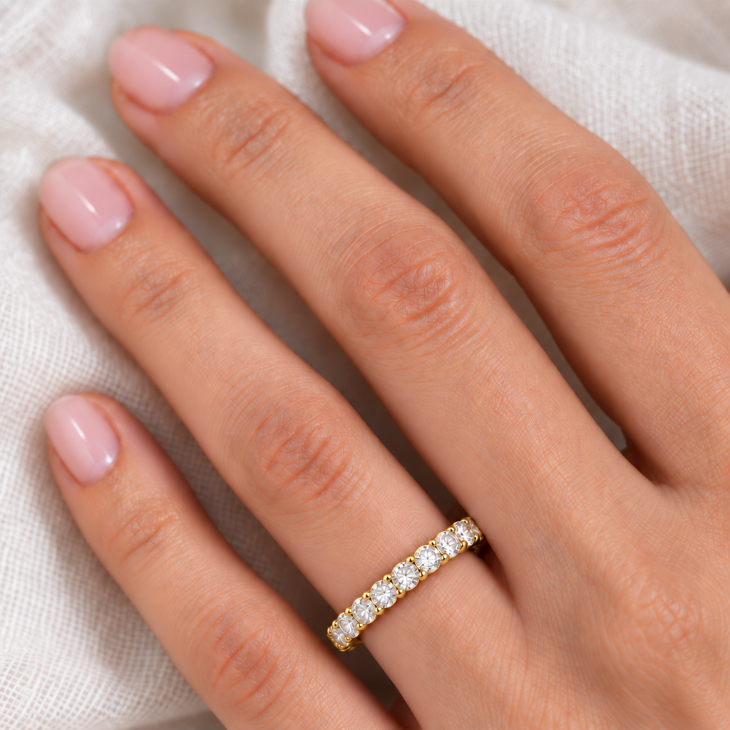 Diamond eternity ring wedding band in 14k yellow gold, 2.50 carats, close-up on ivory linen