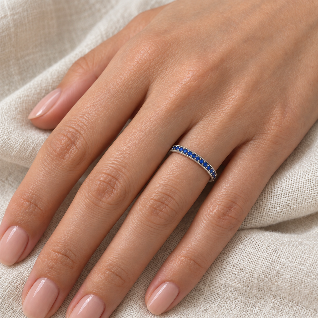 Blue Sapphire Stackable Ring With Milgrain Edges in 14k White Gold — 2 mm band close-up on ivory linen