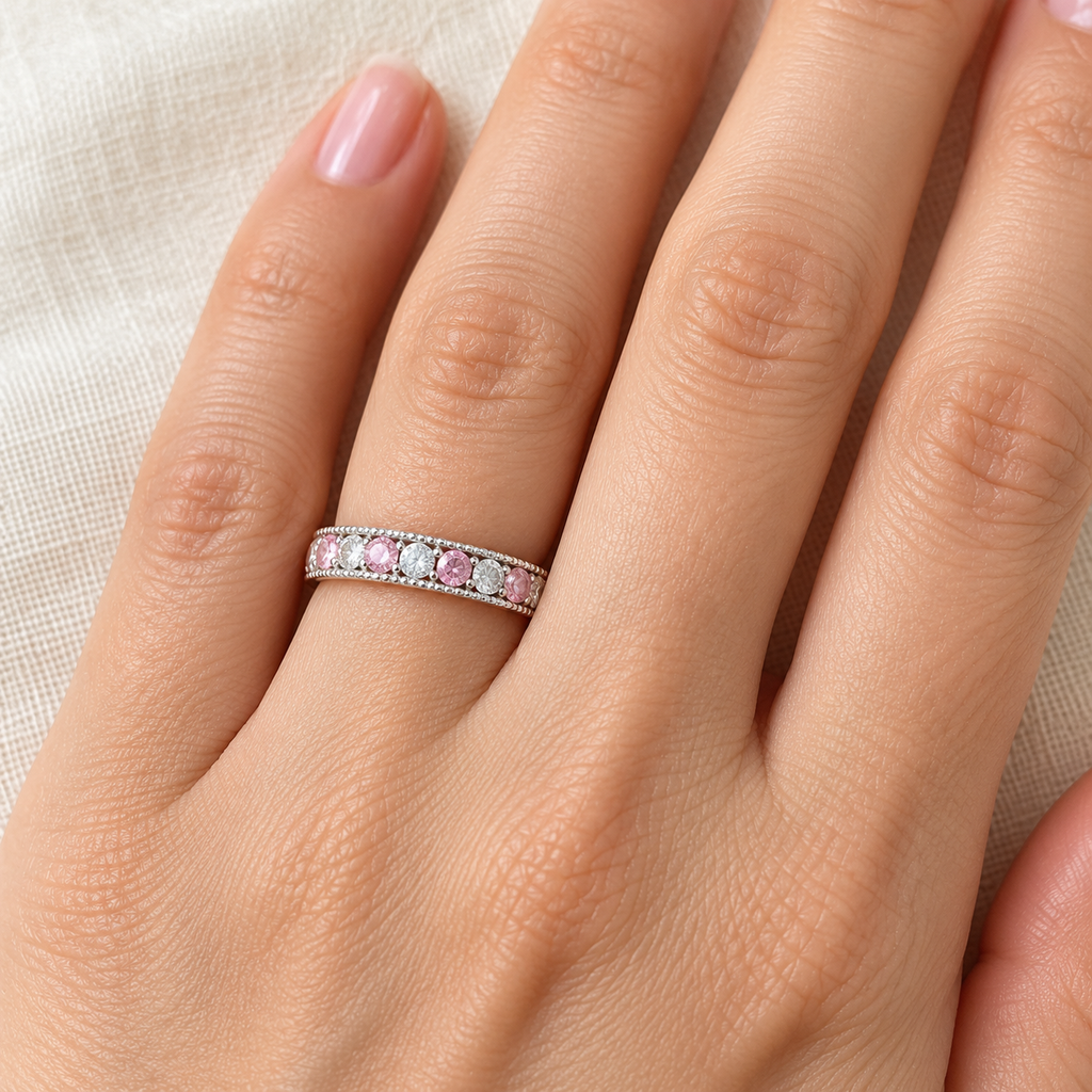 Pink sapphire and diamond anniversary band in 14K white gold, 4 mm, 0.61ct ivory linen hand close-up
