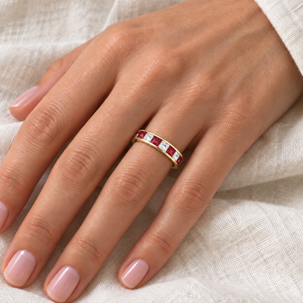 Princess-cut lab ruby and lab-grown diamond channel-set band in14K yellow gold,4mm,0.79ctw — ivory-linen left-hand closeup
