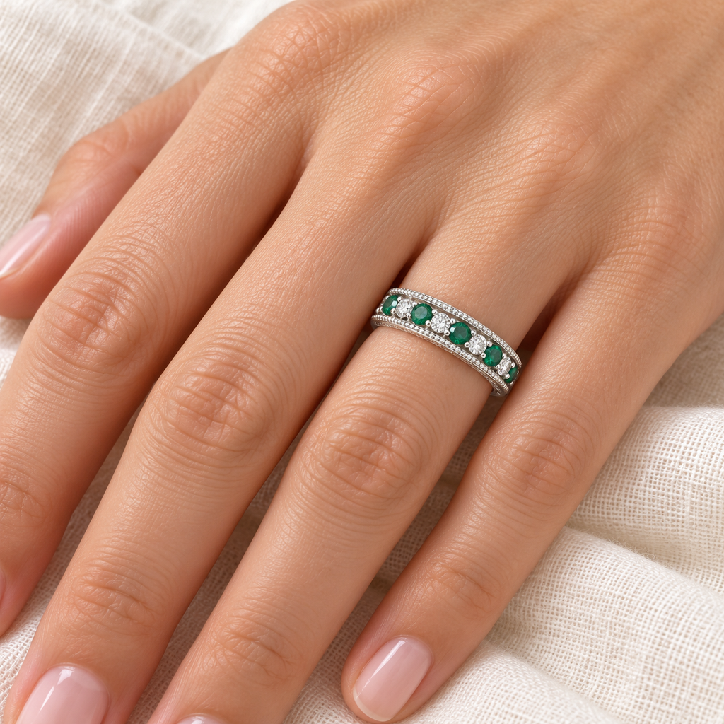 Emerald and diamond anniversary band in 14K white gold, 4 mm, 0.59ct, ivory-linen hand close-up
