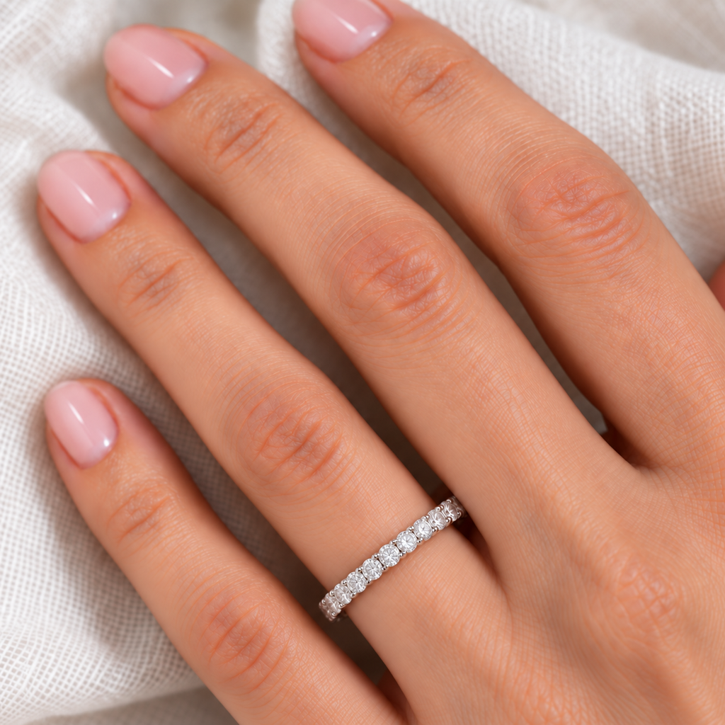 Diamond Eternity Ring Wedding Band in 14k White Gold (2.00ct) — correctly scaled 3mm diamond band on left ring finger over ivory linen