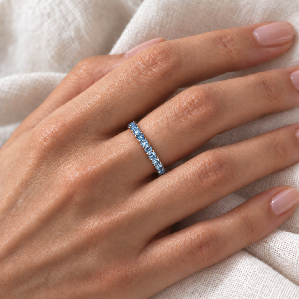 Fancy Lab Blue Lab Diamond Eternity Ring Band 14k White Gold (1.07ct) — correctly scaled fine 2.5mm band on left ring finger over ivory linen