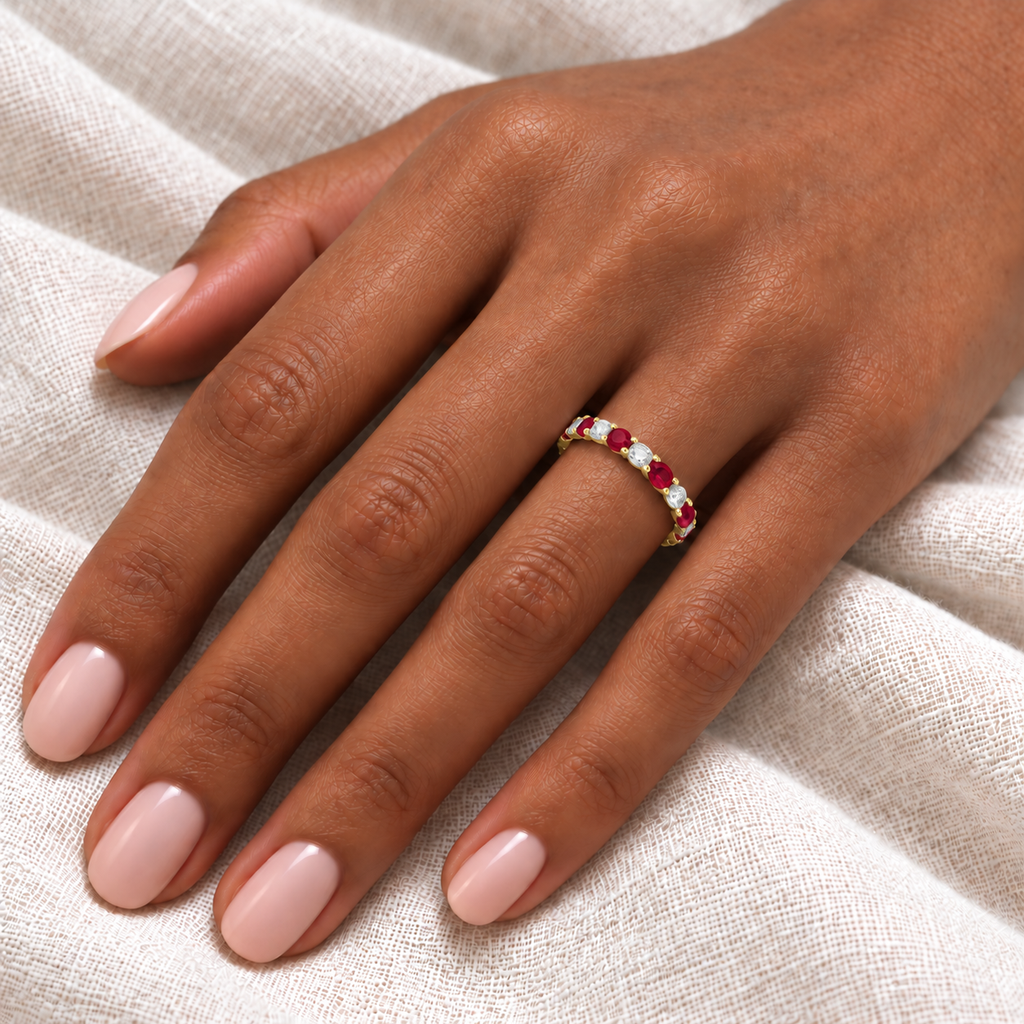 Ruby and diamond eternity ring on hand, ivory linen close-up