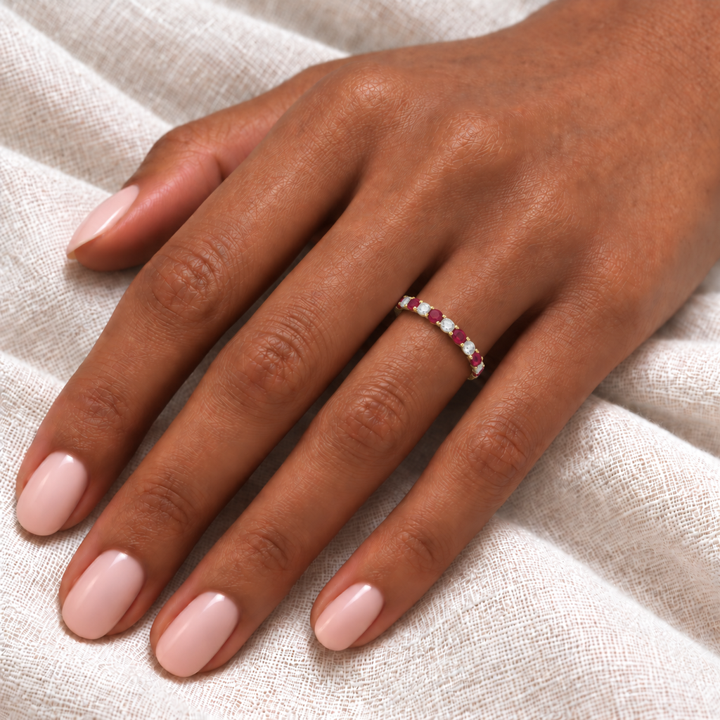 IR534LG lab ruby and lab diamond 2.5mm eternity ring on left hand over ivory linen, realistic fine scale