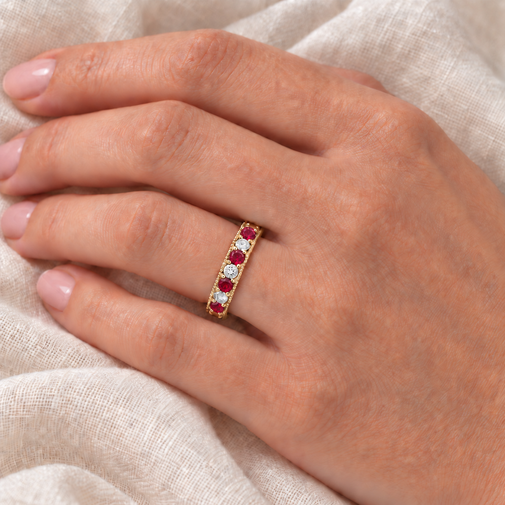 4mm natural ruby and diamond anniversary ring band in 14k yellow gold on left hand over ivory linen