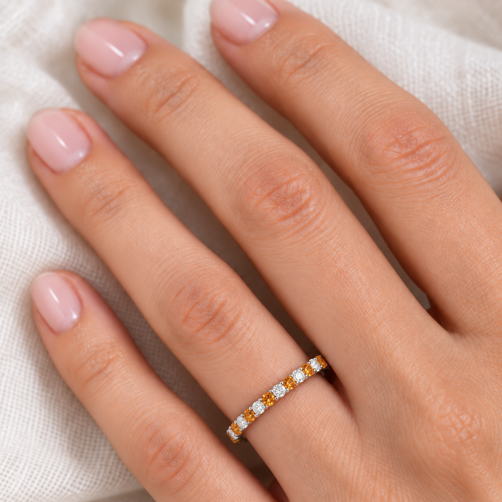 Lab citrine and lab diamond eternity ring in 14k white gold, fine-scale ivory-linen hand close-up