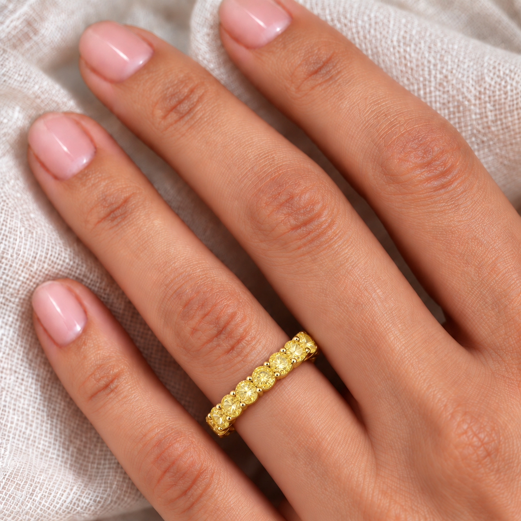 Fancy canary yellow diamond eternity ring band in 18k yellow gold, 3.00ct, ivory linen hand closeup