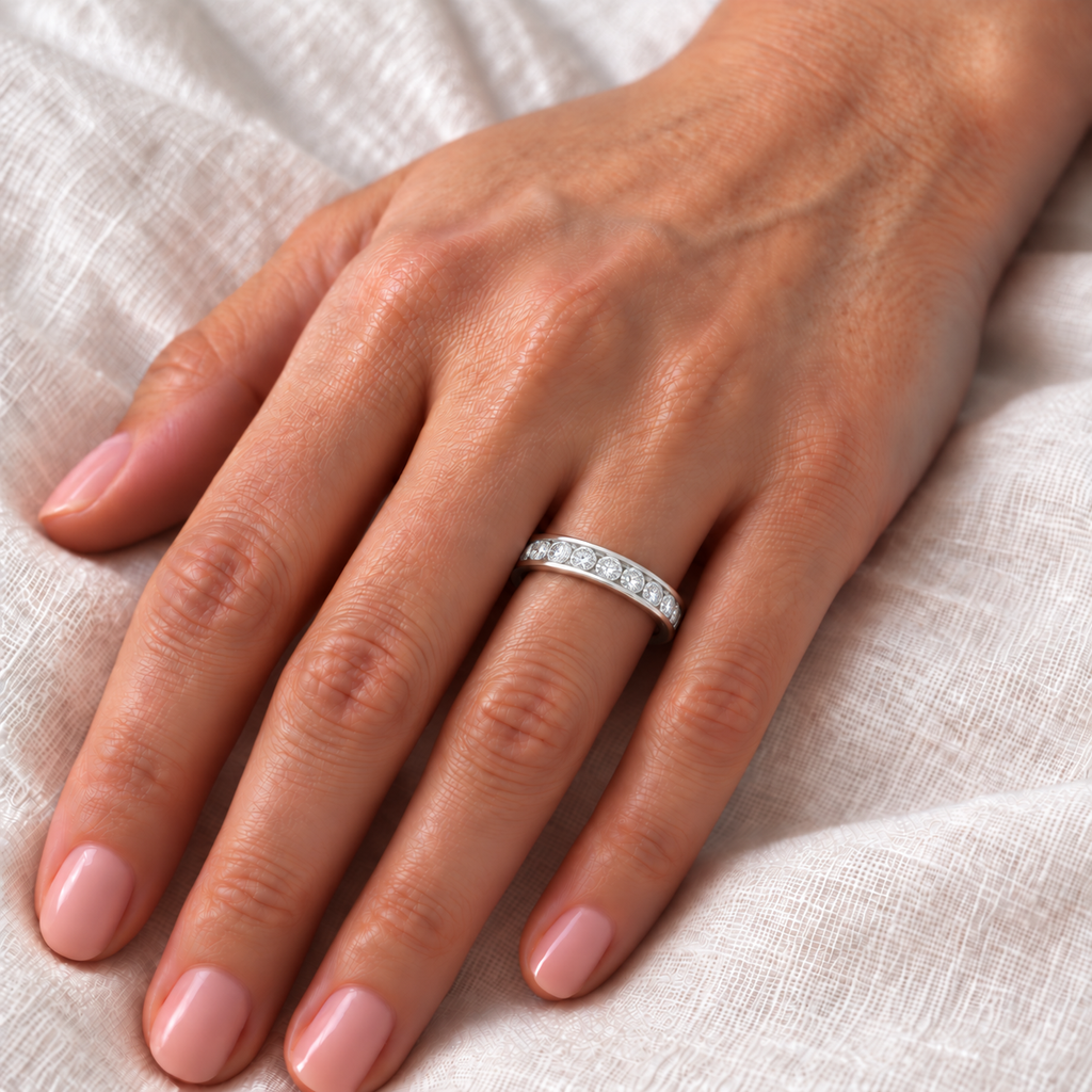 0.50ct natural diamond channel band in 14k white gold, accurate 3mm scale on left ring finger over ivory linen