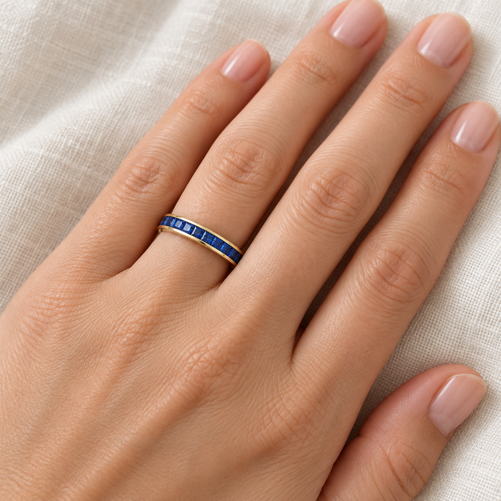 Natural blue sapphire 3 mm princess-cut eternity band in 14k yellow gold — ivory-linen close-up